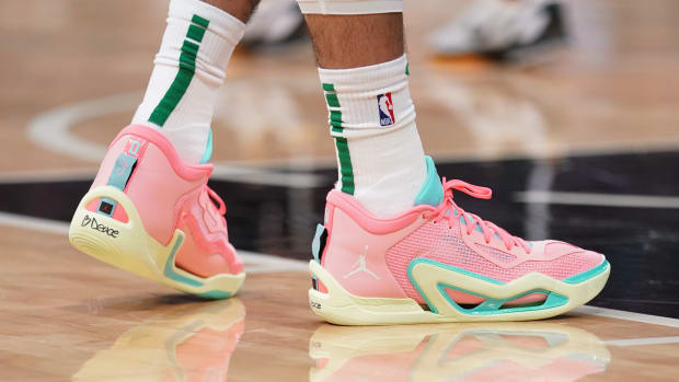 View of Jayson Tatum's pink and green Jordan Brand shoes.